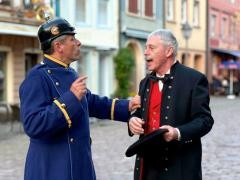 Zwei Darsteller von Theres im Kaiserfieber stehen auf dem Marktplatz.