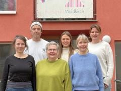 Eine Gruppe Menschen steht vor dem Eingang des Roten Haus