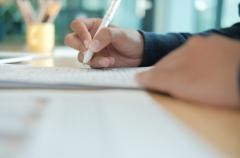 Eine Person füllt einen Antrag aus.